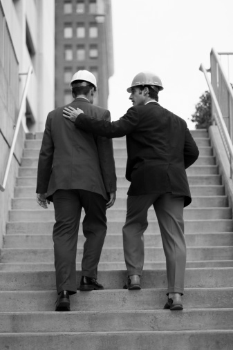 two industry leaders climbing stairs and collaborating in a city